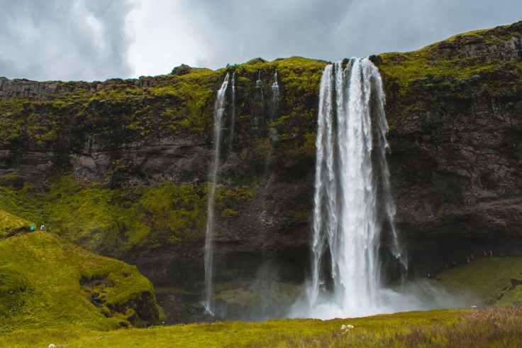 photo of waterfalls during cloudy sky